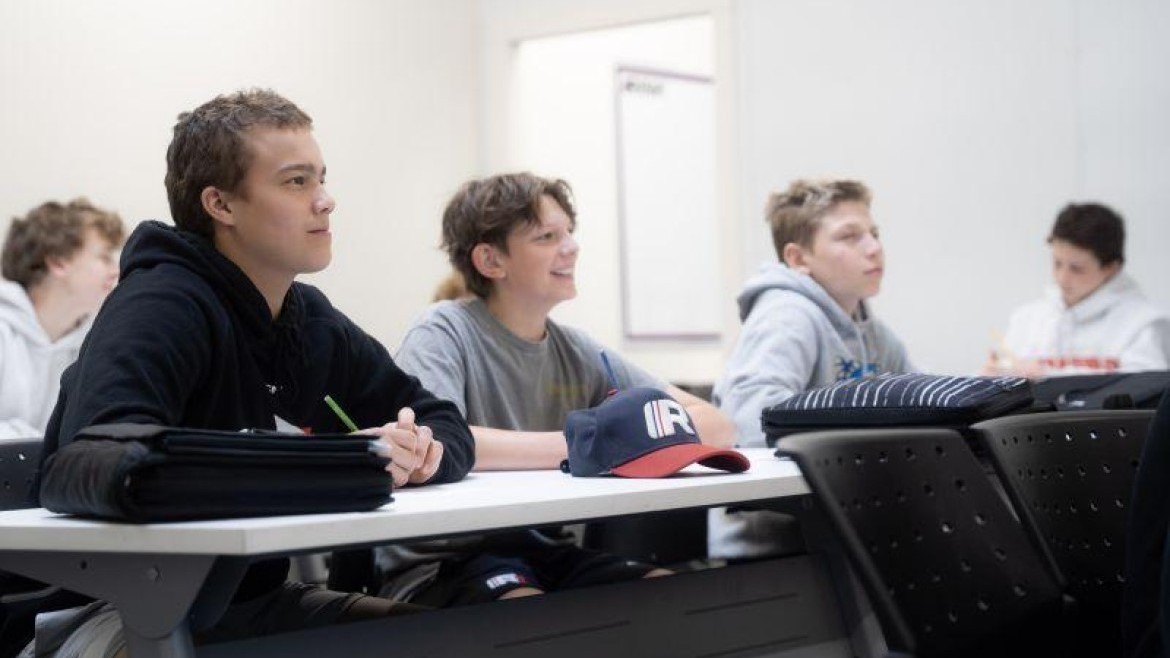 Image of three students sitting in a row at RINK Hockey Academy